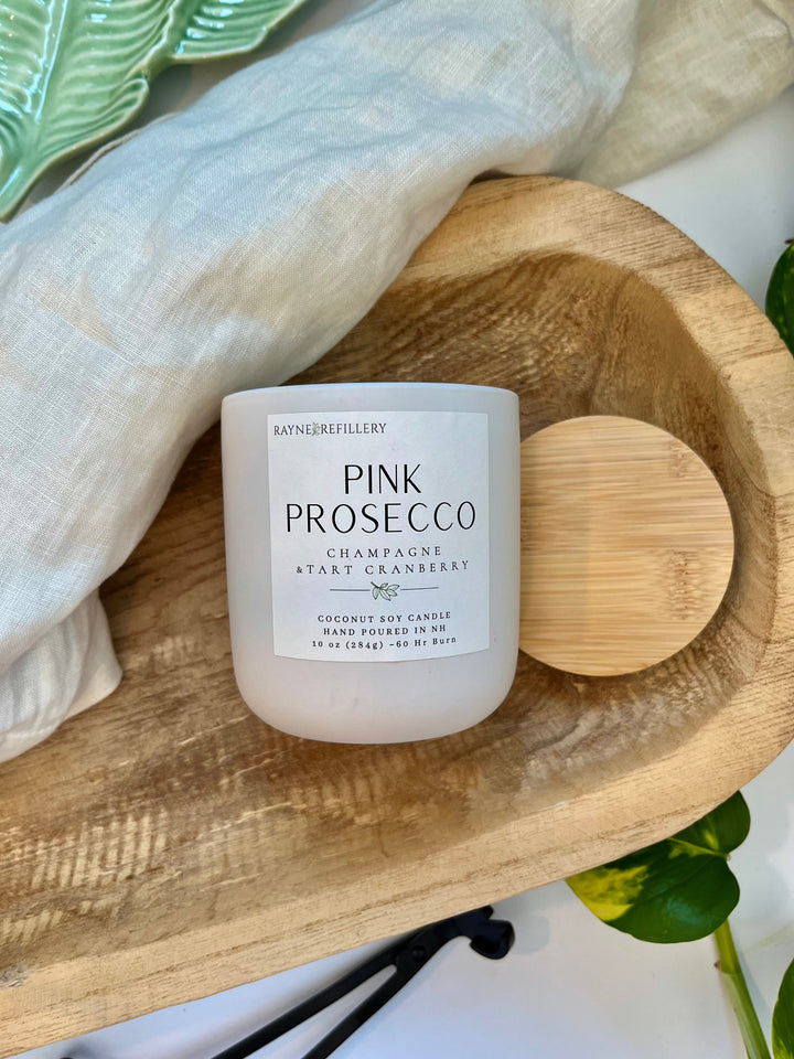 Pink Prosecco coconut soy candle in white jar with wooden heart lid on tray