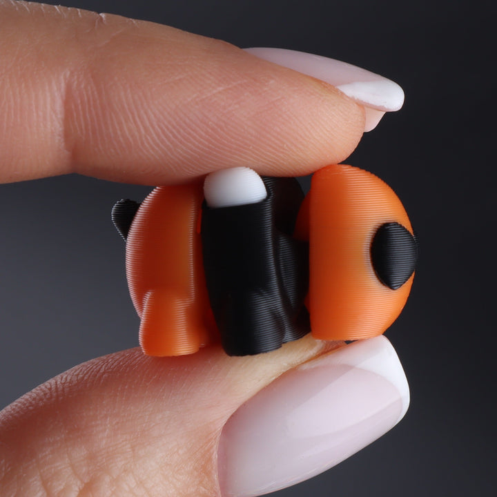 Orange and black animal fidget toy with rounded body and side fin detail