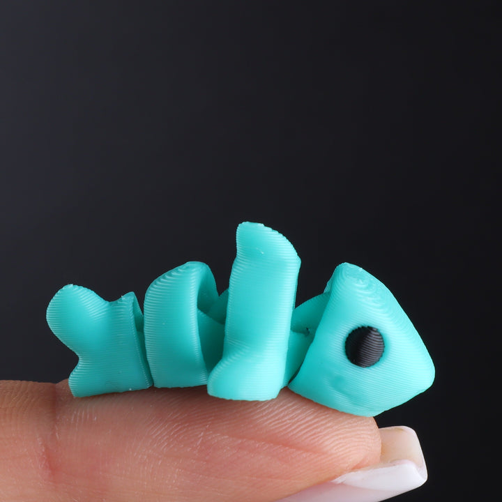 Teal animal fidget toy with black oval eye and curled tail segments
