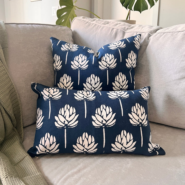 Navy blue linen throw pillow cover with repeating white leaf sprig pattern