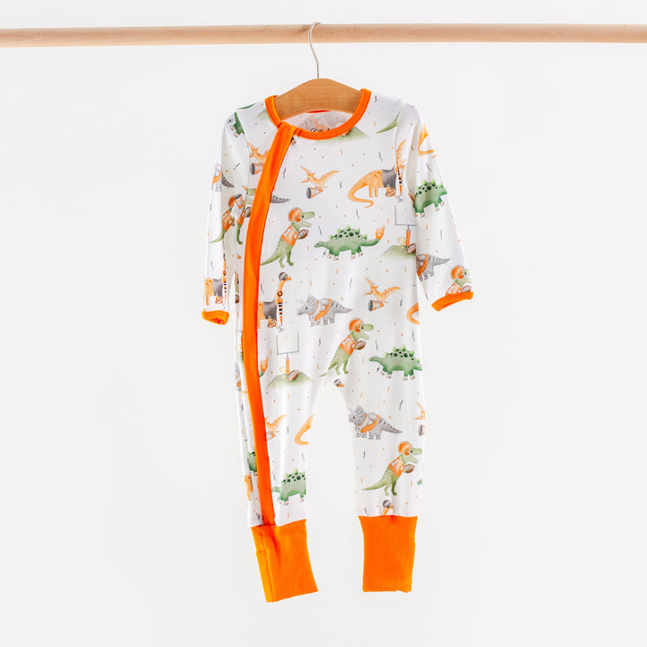 Kids long-sleeve pajama set, white with dinosaur scene print and bright orange trim