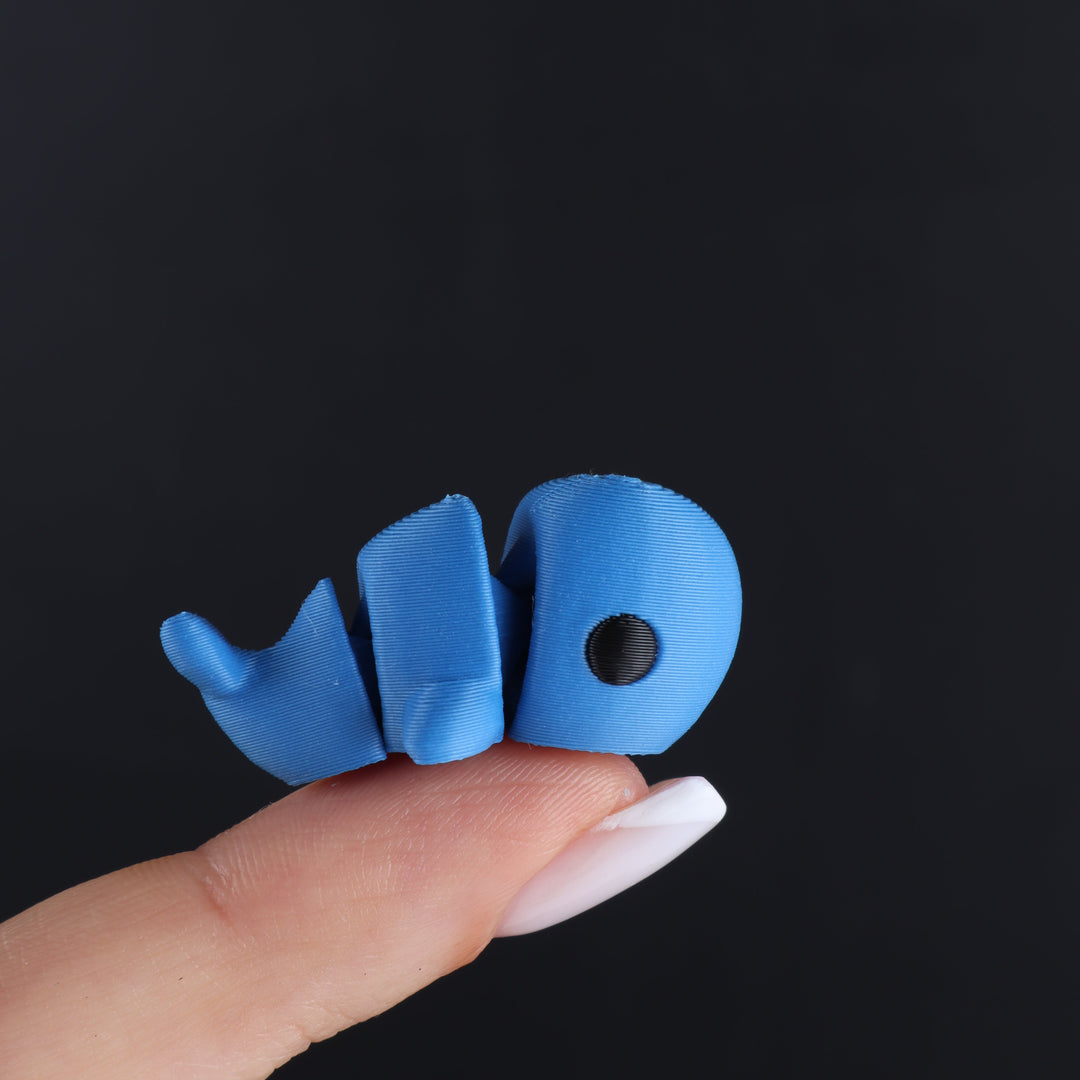 Light blue animal fidget toy with black oval eye and curled tail pieces