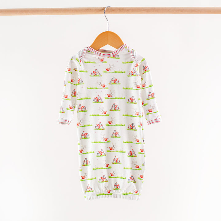 Kids white dog-print pajama top and pants set, red-and-blue striped trim at cuffs
