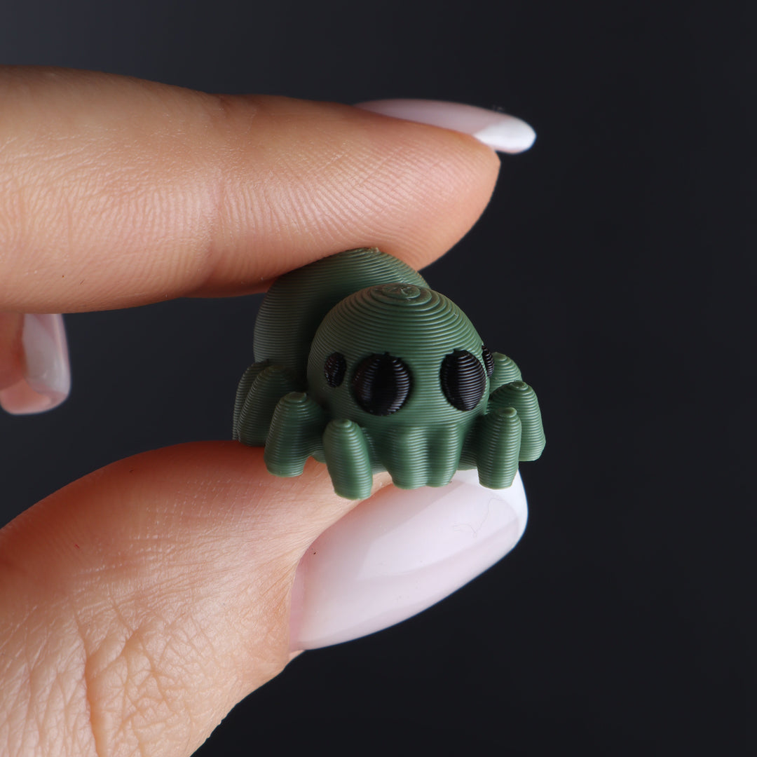 Green animal fidget toy with big round eyes and ribbed tentacles