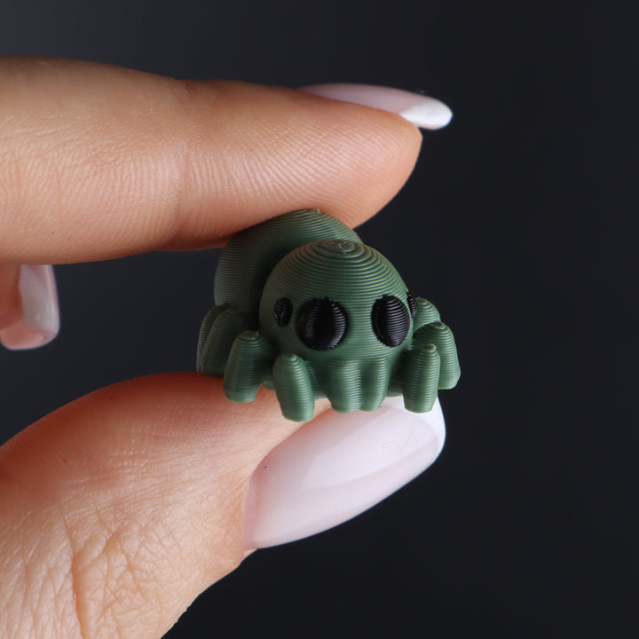 Green animal fidget toy with big round eyes and ribbed tentacles