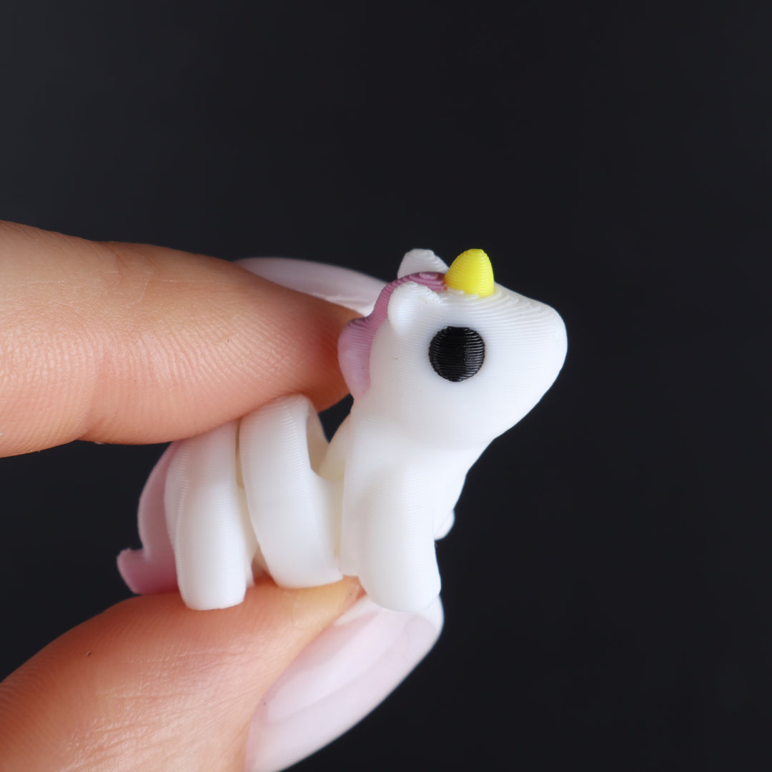 White animal fidget toy with lime horn and round black eye