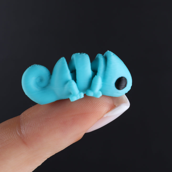Blue animal fidget toy with spiral tail and round black eye