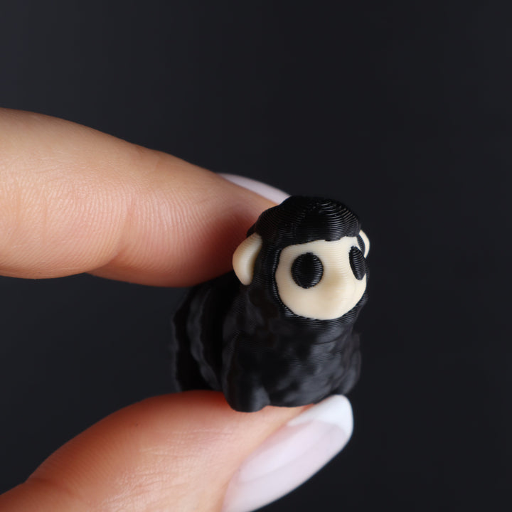 Black animal fidget toy with white face and round black eye