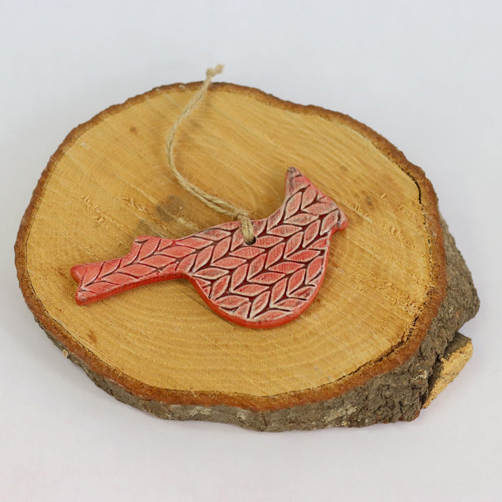 Ceramic cardinal ornament, red patterned bird on wooden slice with hanging string