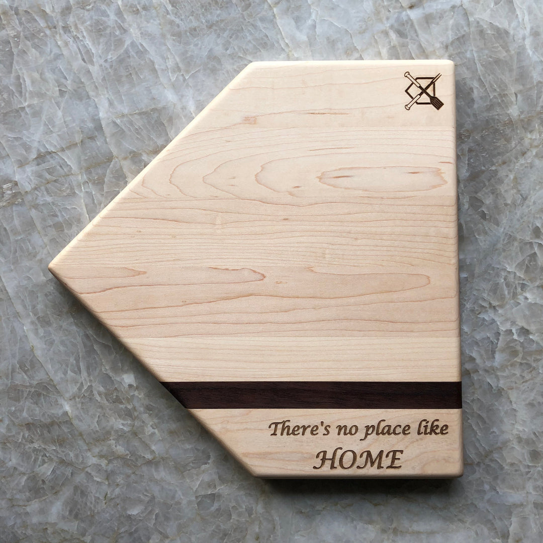 Home plate cutting board with engraved crossed logo and 'There's no place like HOME' text