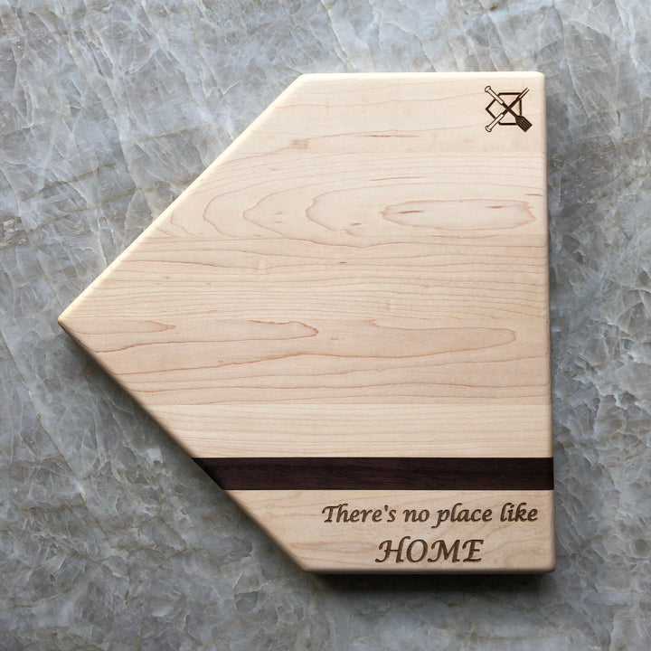 Home plate cutting board with engraved crossed logo and 'There's no place like HOME' text