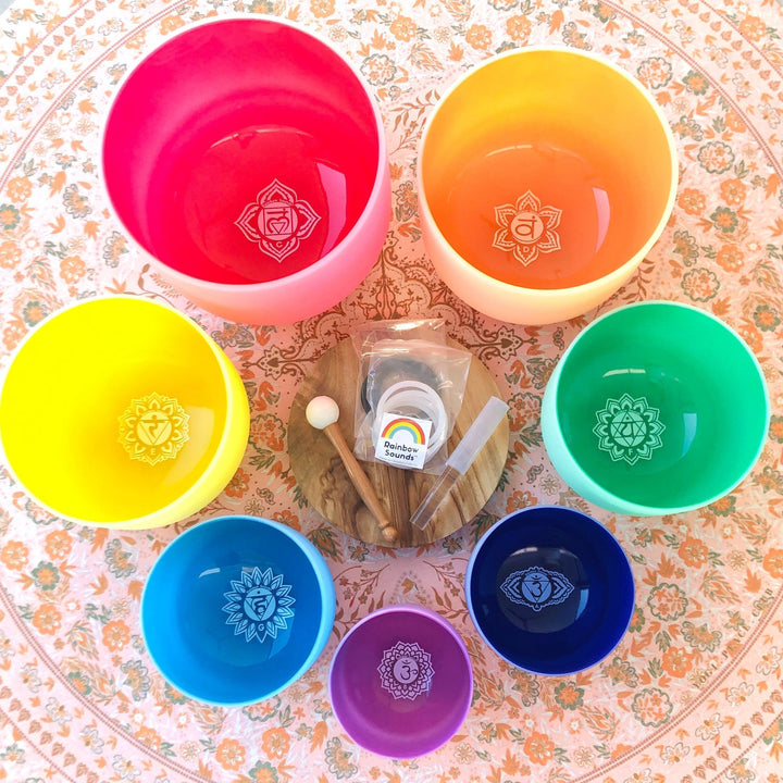 Colorful sound therapy bowls: red, orange, yellow, green, blue, dark blue, purple