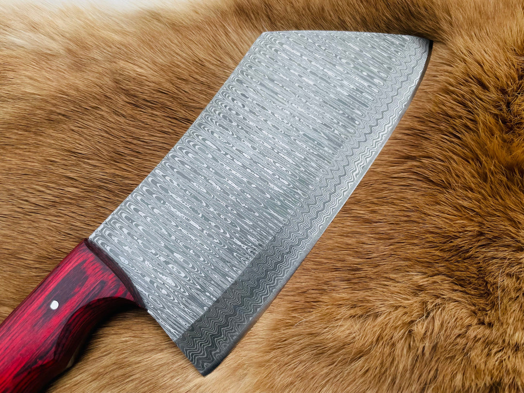 Damascus steel cleaver blade with red handle, full length view