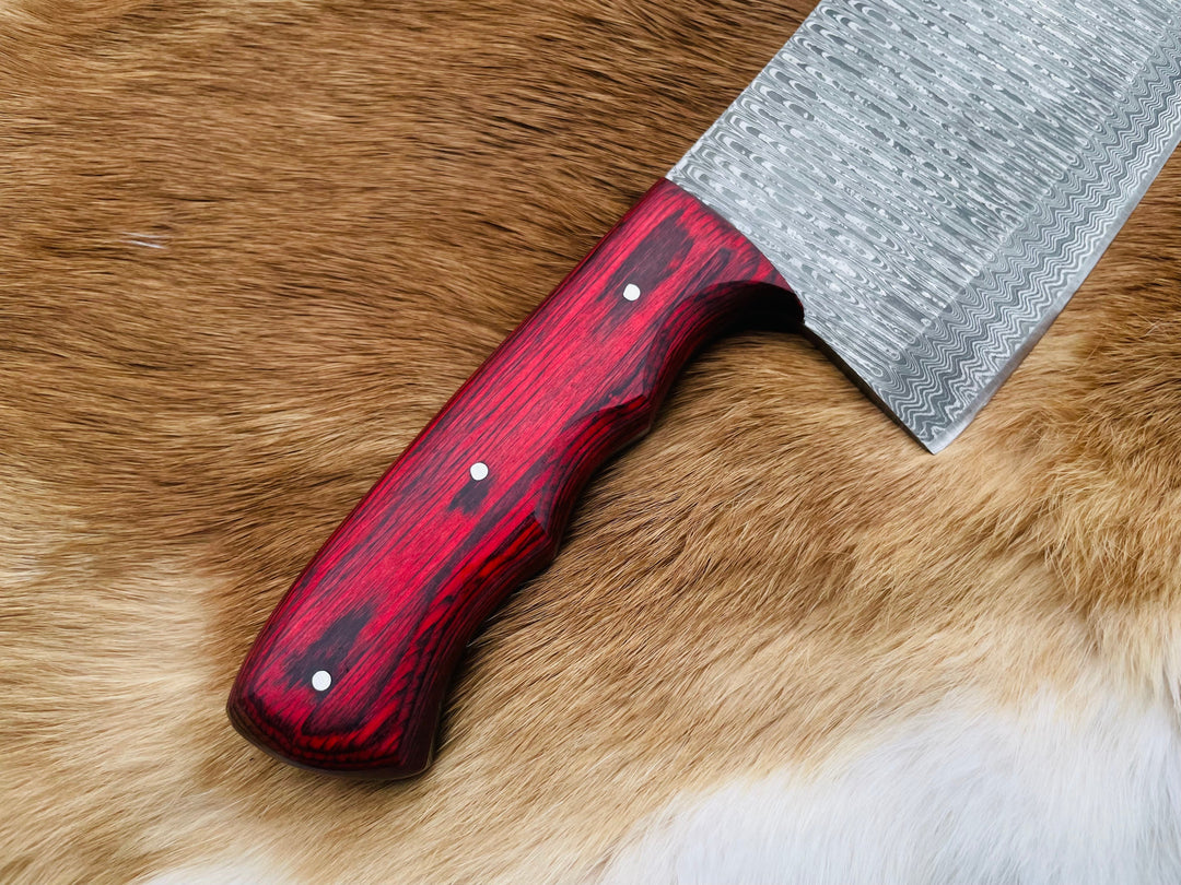 Damascus kitchen cleaver with glossy red handle and rivets