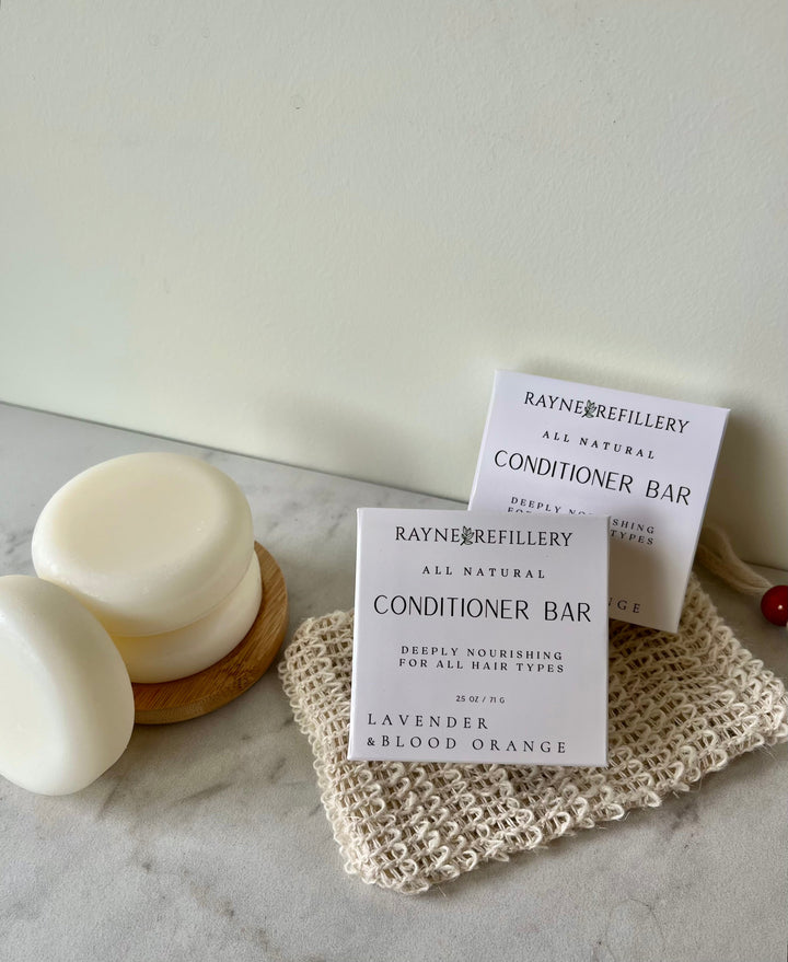 Rayner Refillery conditioner bar labeled Lavender & Blood Orange beside white bars