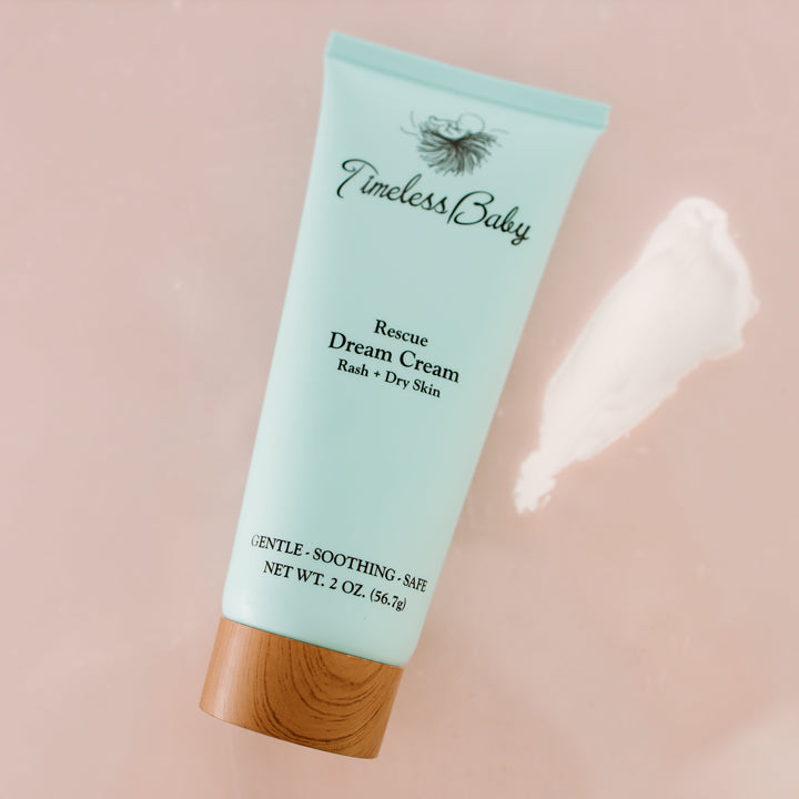 Angled light blue Rescue Dream Cream baby cream tube with wood base
