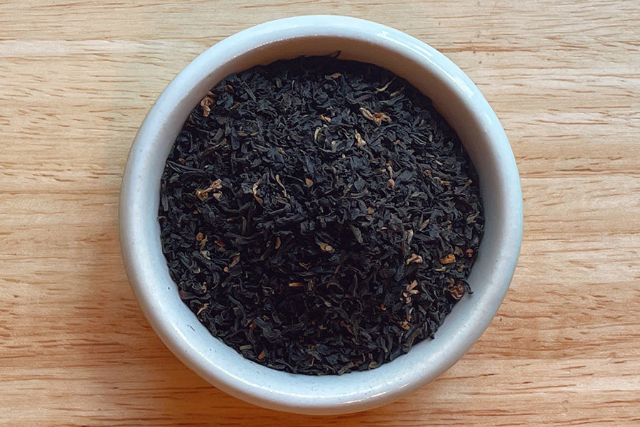 Loose black tea leaves in ceramic bowl