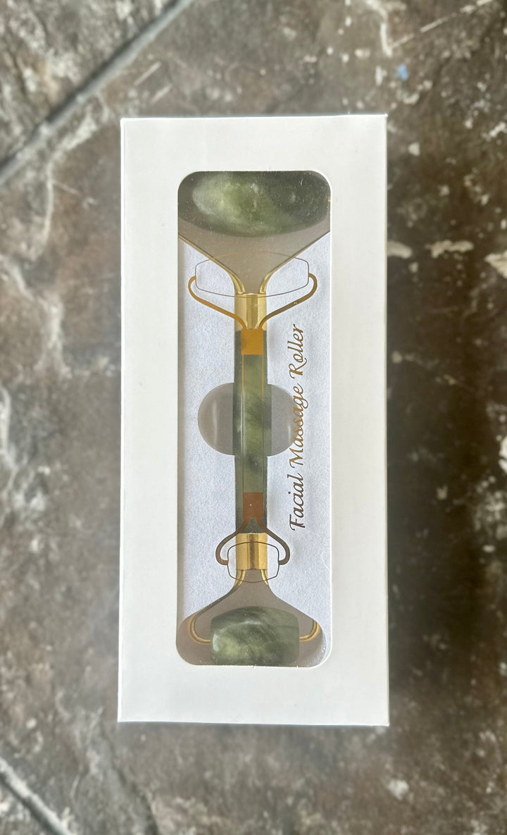 Jade facial roller in retail box with two green stones and gold-tone frame