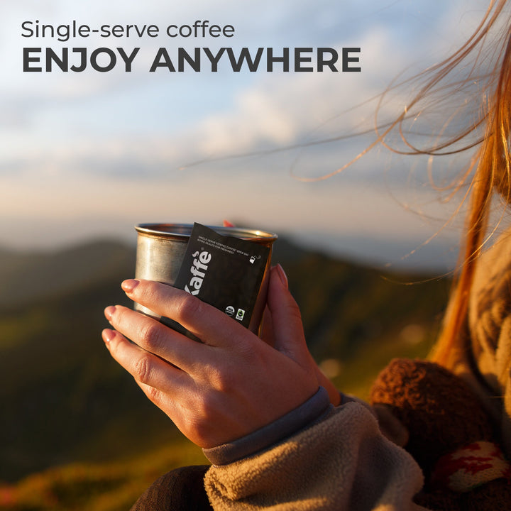 Single-serve coffee steeped bag held near a cup for enjoying anywhere