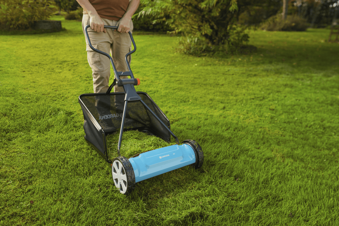 Black grass catcher bag on a lawn mower, open top with rigid support frame.
