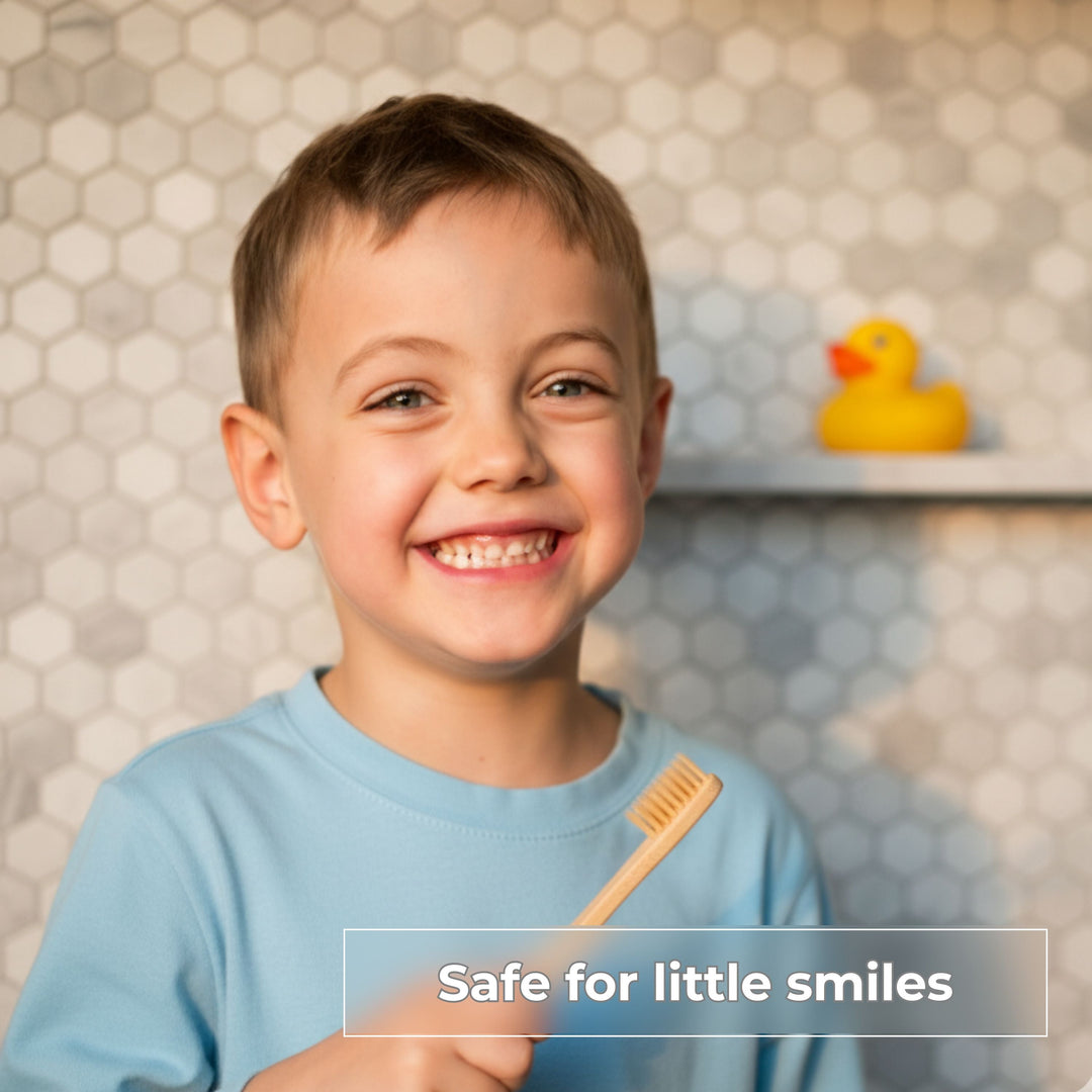 Child smiling while brushing teeth with fluoride-free cinnamon toothpaste tablet