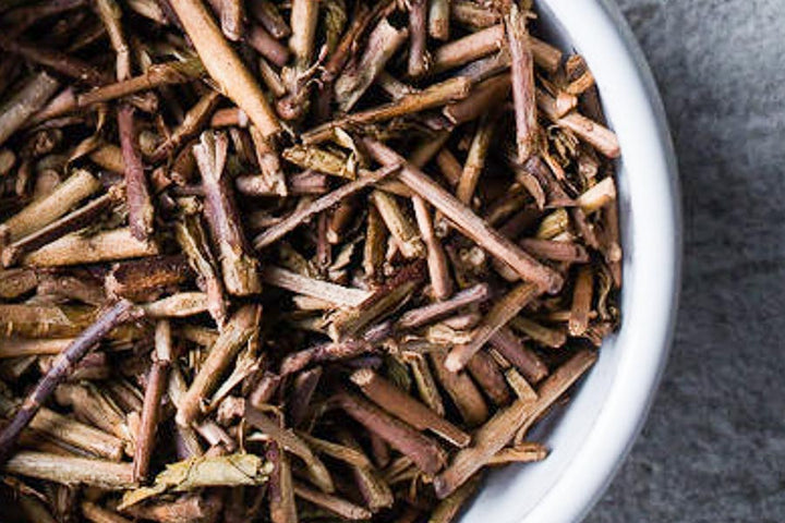 Toasted kukicha tea, loose roasted stems in a metal bowl