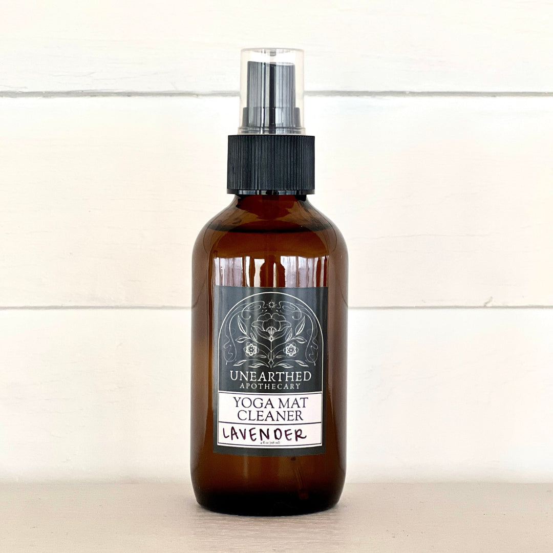 Yoga mat cleaning spray bottle with lavender label, amber glass and black mist sprayer