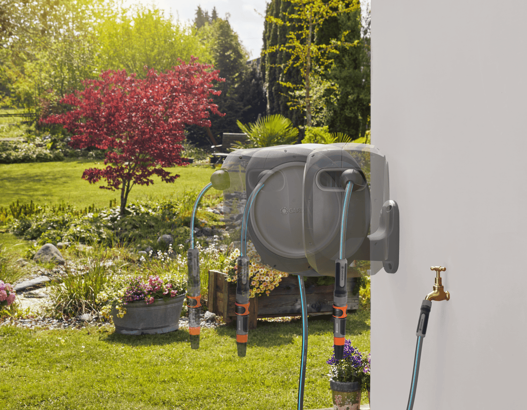Wall-mounted retractable hose reel with extended hose and brass faucet connections