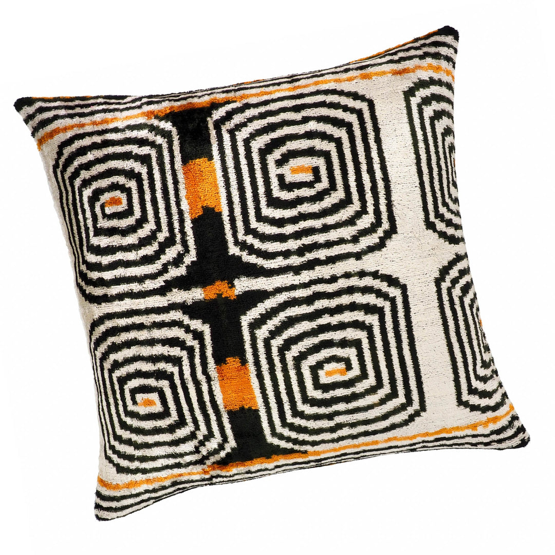 Silk velvet pillow cover with cream and black labyrinth ikat design and orange accents