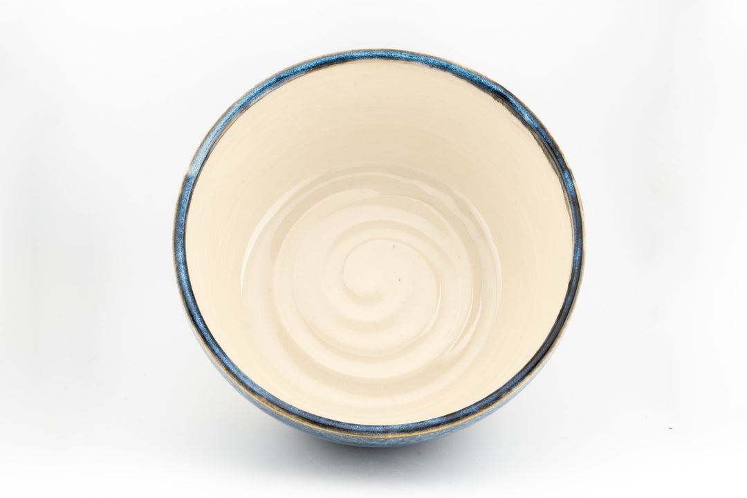 Ceramic bowl interior with cream center and thin blue rim edge