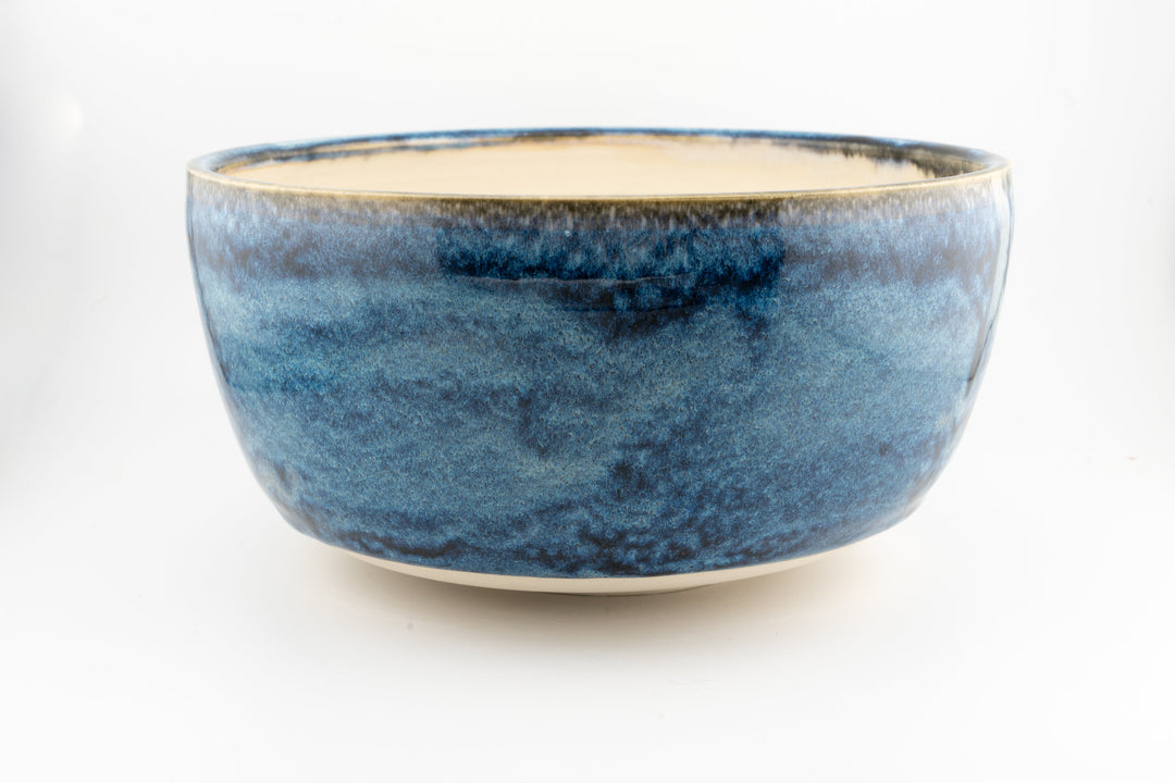 Ceramic large bowl with deep blue glaze and creamy interior, smooth rim