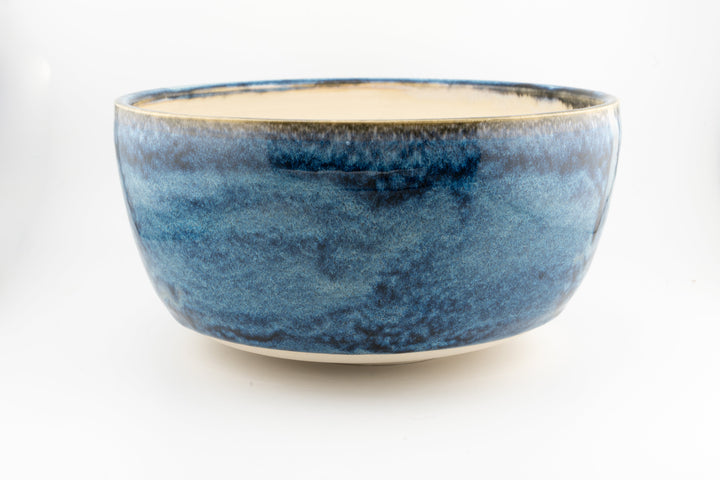 Ceramic large bowl with deep blue glaze and creamy interior, smooth rim