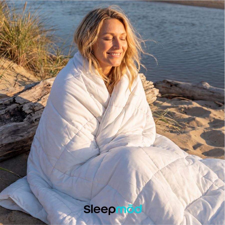 White cooling comforter wrapped around a seated person