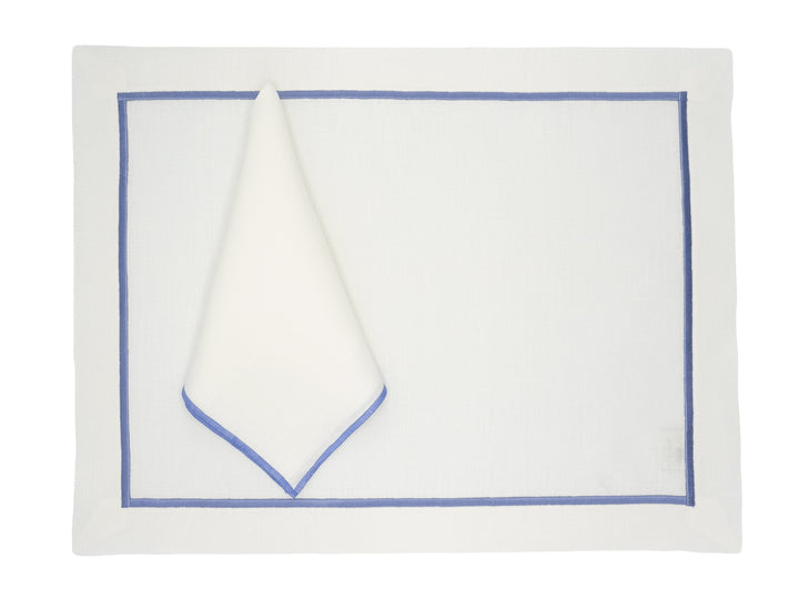 Linen placemat with blue border, folded into a triangle centerpiece
