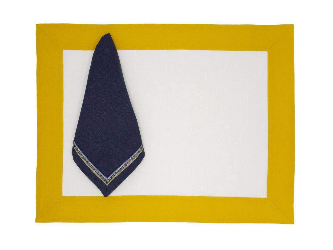 Linen placemat with mustard border, navy corner fold and white center