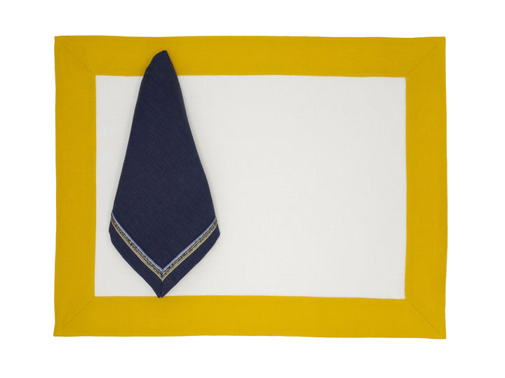 Linen placemat with mustard border, navy corner fold and white center