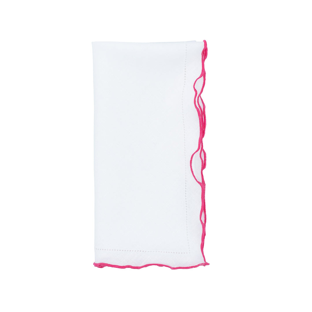 White linen napkin with pink ruffled hemstitch trim along the side edge