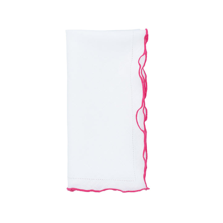 White linen napkin with pink ruffled hemstitch trim along the side edge