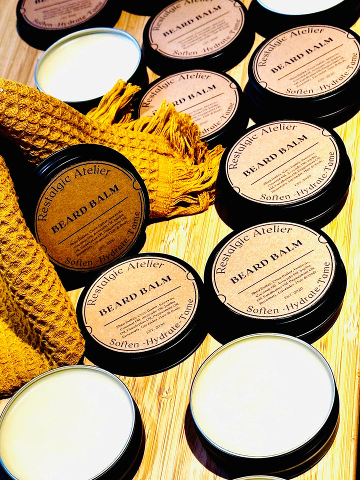 Assorted beard balm tins with white lids, round black containers