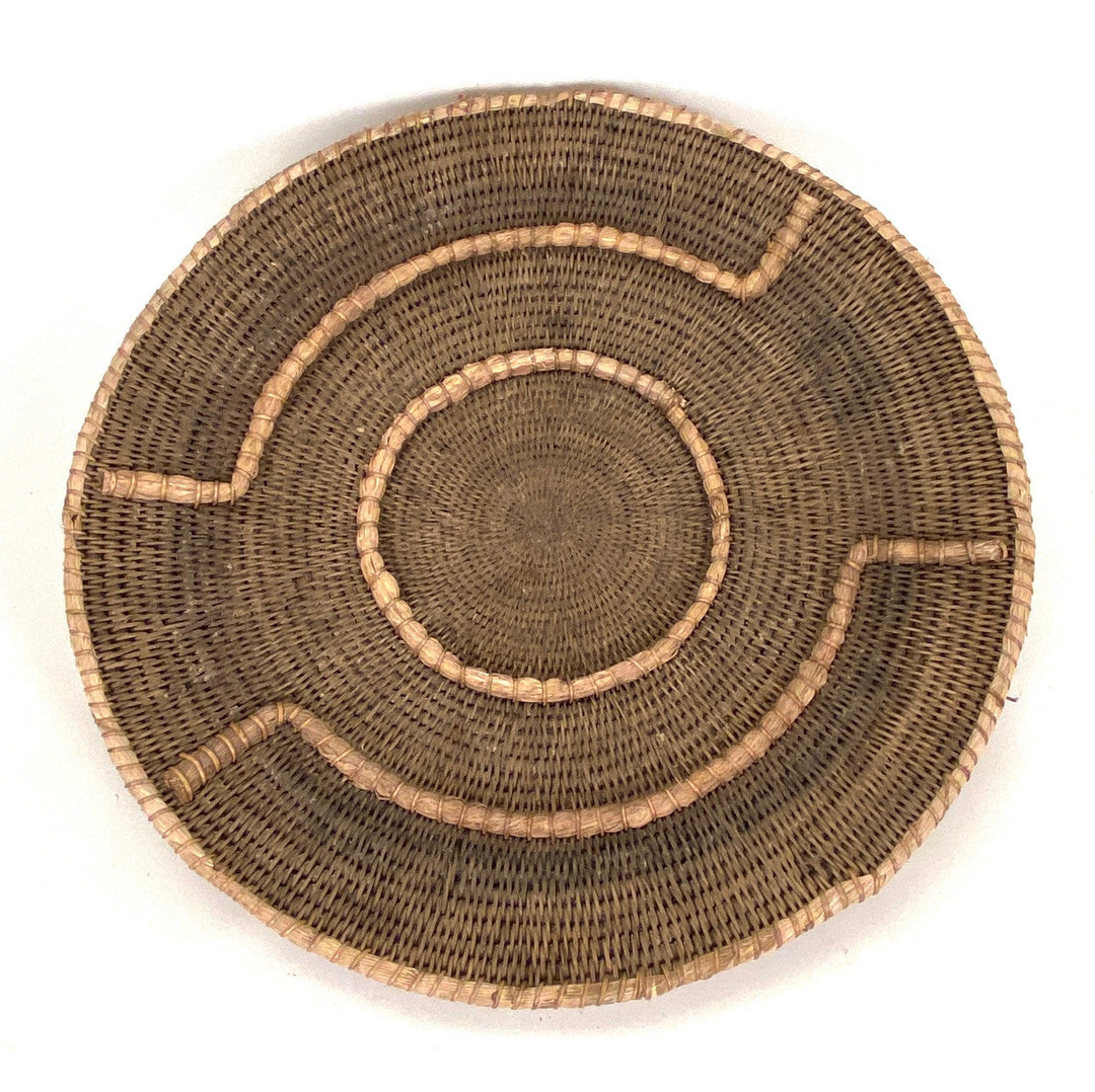 Small woven basket in dark brown with tan stitched ring and curved cutout accents