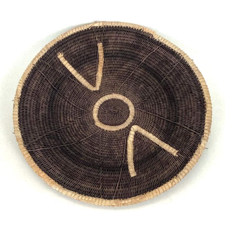 Small woven basket, dark brown with tan stitched V lines and a center circle motif