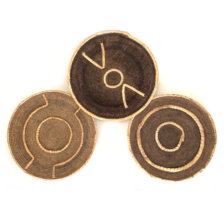 Set of three small woven baskets in dark brown with tan stitched circle motifs
