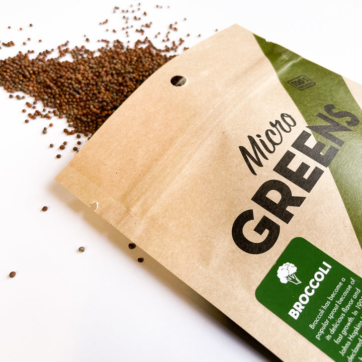 Broccoli microgreen seed bag with scattered dark seeds beside it