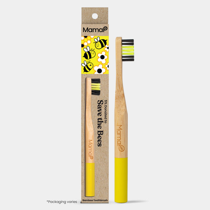 Kids bamboo toothbrush with yellow handle and soft neon-yellow bristles in carton