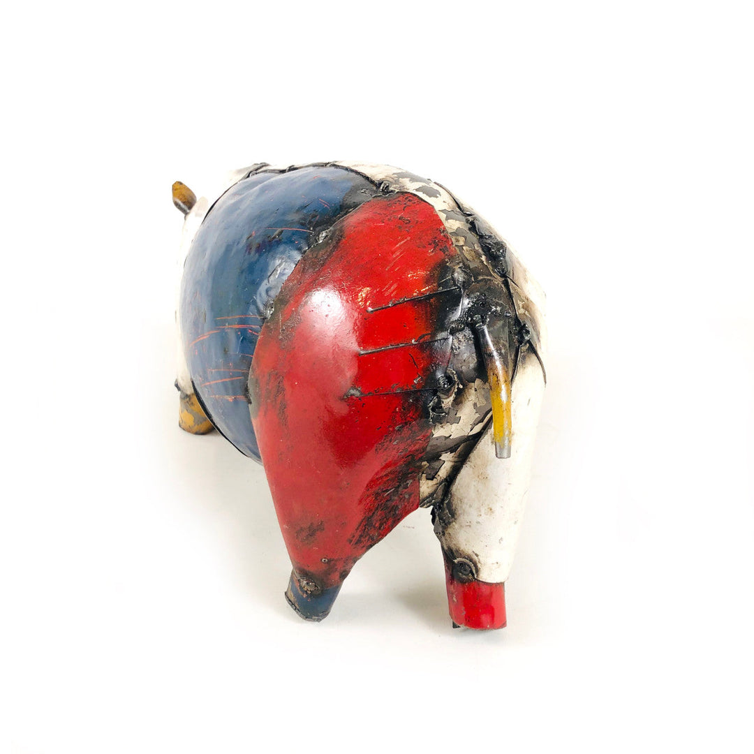 Recycled metal pig figurine back view, red and blue panels with yellow accents