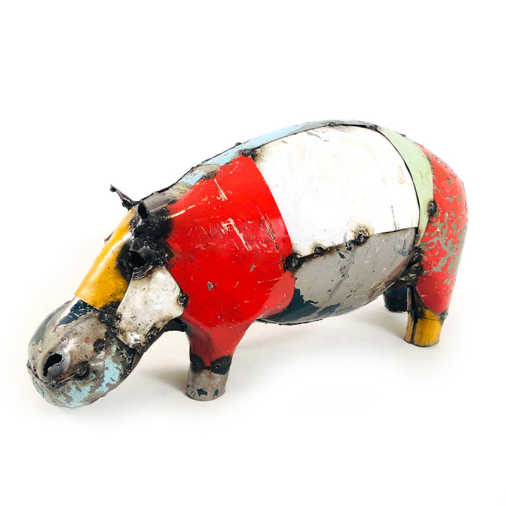 Recycled metal pig figurine with red, white, and yellow stripes, side view