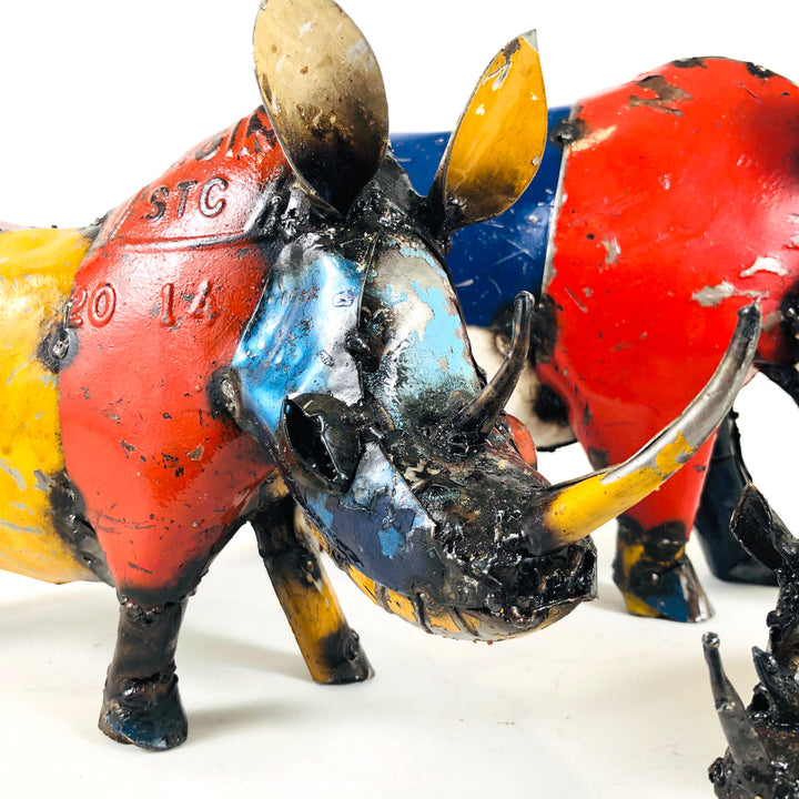 Recycled metal rhino sculpture close-up of head with black horns and multicolor body paint