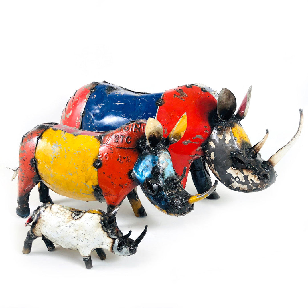 Recycled metal rhino sculpture with colorful red, blue, and yellow body panels and horns