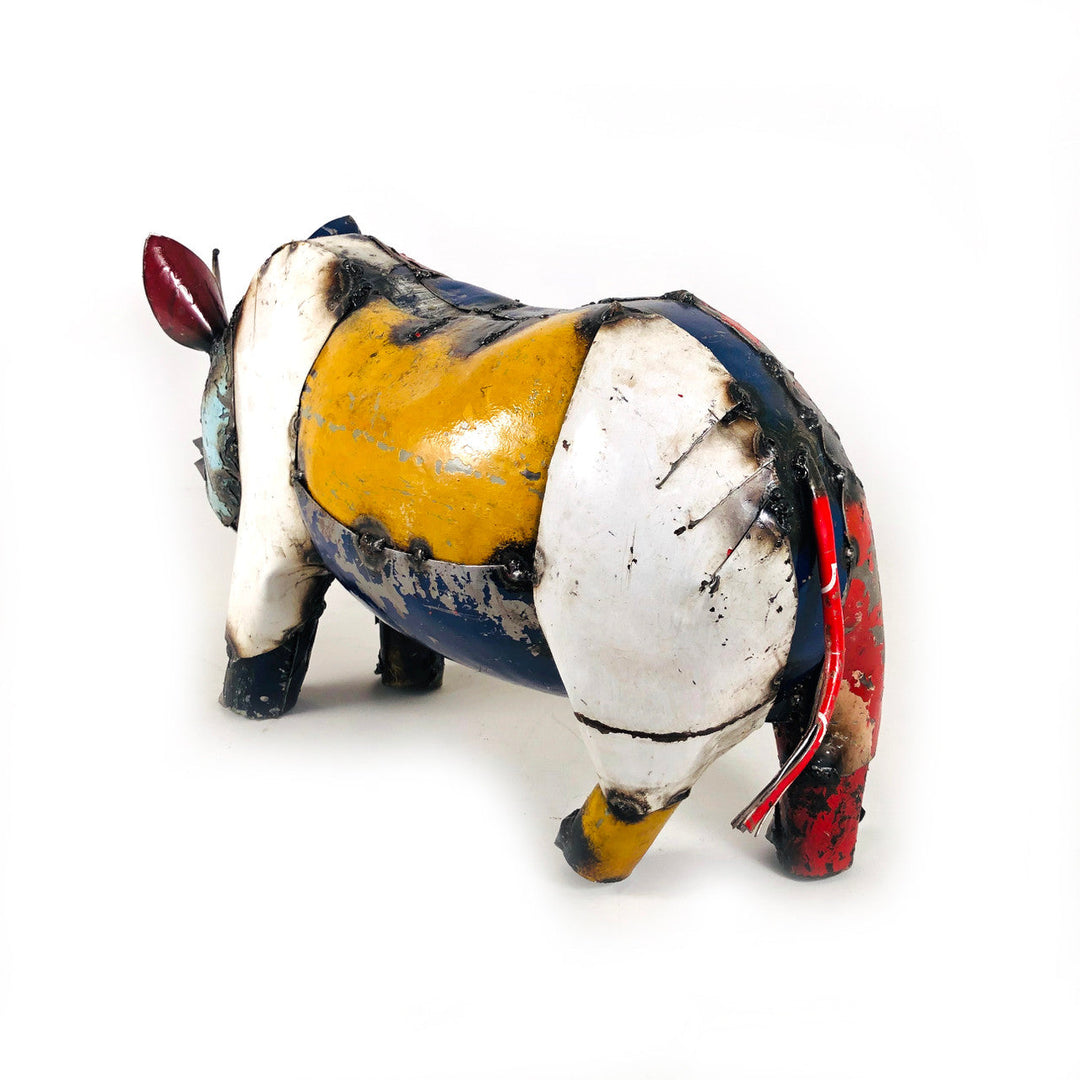 Recycled metal rhino sculpture, rear view, white and blue body with yellow panel and tail
