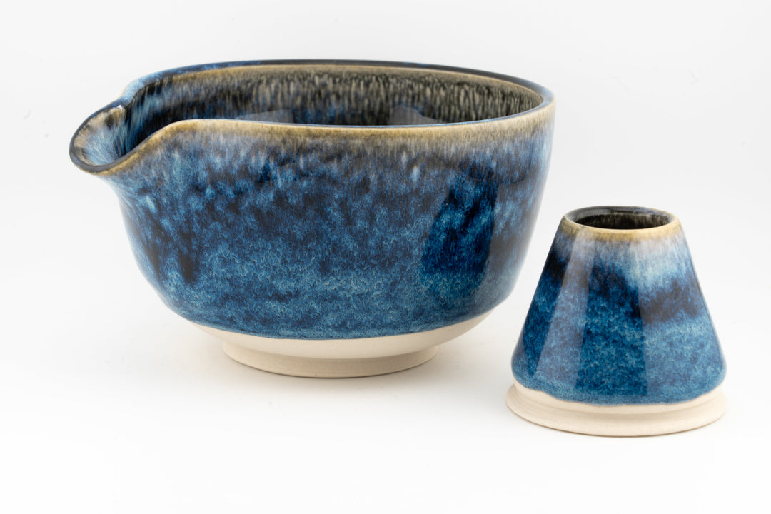 Blue ceramic matcha bowl with short handle plus matching whisk holder on white base